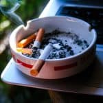 Cigarettes in an ashtray, symbolizing the harmful effects of smoking and the importance of breaking bad habits for better preparedness.