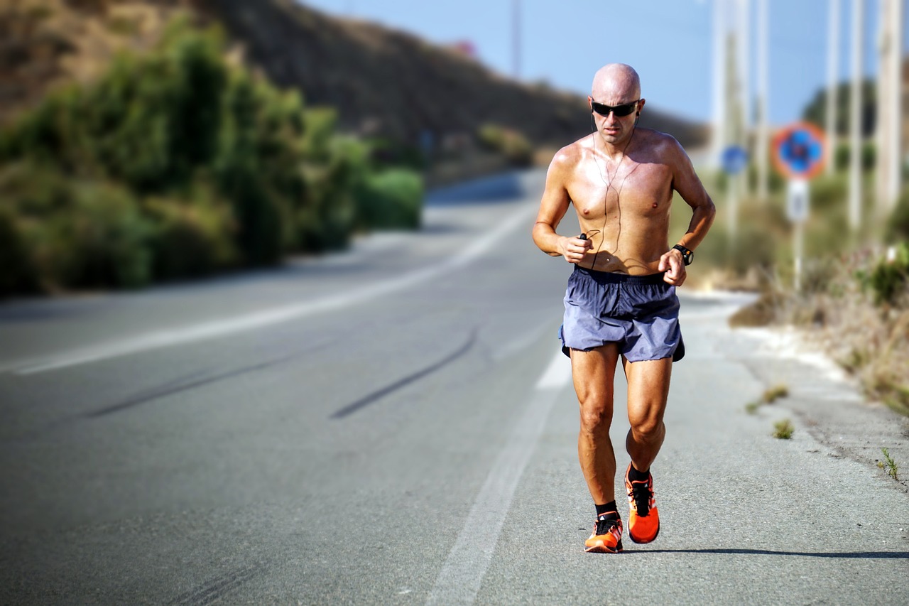 A physically fit man running outdoors as part of an emergency preparedness routine.