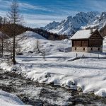 A remote cabin in a snowy landscape, representing "Bug Out Location Selection: Urban vs Rural Retreats"